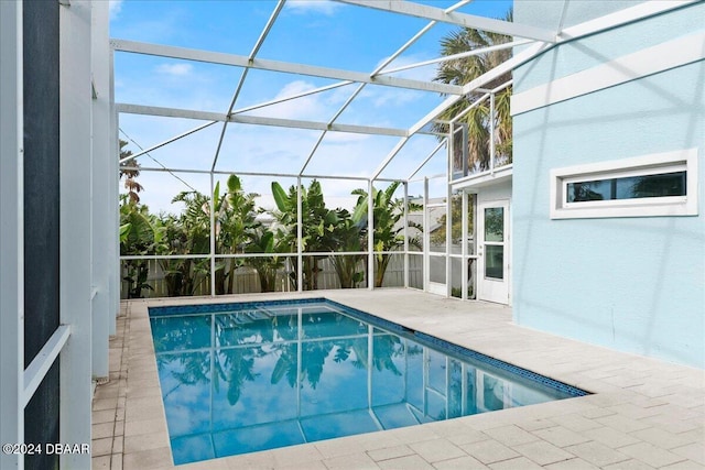 view of pool with a lanai and a patio