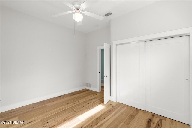 unfurnished bedroom with ceiling fan, a closet, and light hardwood / wood-style flooring