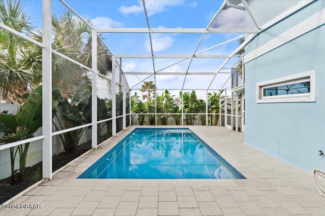 view of pool featuring a patio area and a lanai