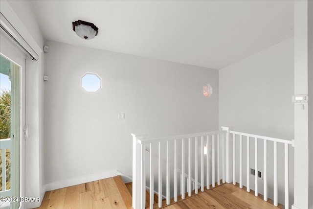 stairs with wood-type flooring and a wealth of natural light