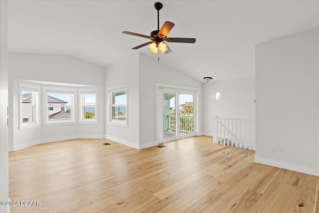 unfurnished living room featuring ceiling fan, lofted ceiling, and light wood-type flooring