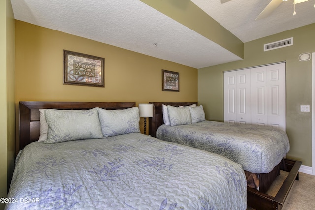 2071 S Atlantic Ave Unit 605, Daytona Beach, FL 32118 - carpeted bedroom featuring a closet, a ceiling fan, baseboards, and a textured ceiling