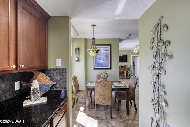 2071 S Atlantic Ave Unit 605, Daytona Beach, FL 32118 - dining room with tile patterned flooring, ceiling fan, and a textured ceiling