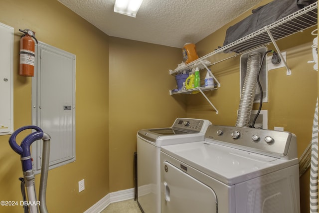 2071 S Atlantic Ave Unit 605, Daytona Beach, FL 32118 - washroom with independent washer and dryer, a textured ceiling, electric panel, and baseboards