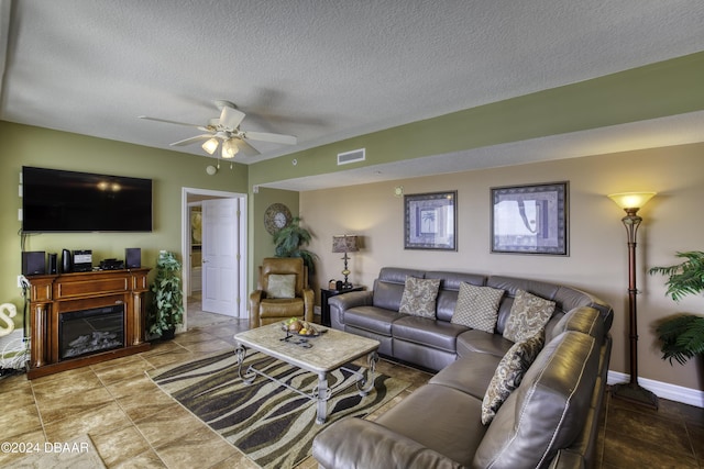 2071 S Atlantic Ave Unit 605, Daytona Beach, FL 32118 - living room featuring ceiling fan, a textured ceiling, and baseboards