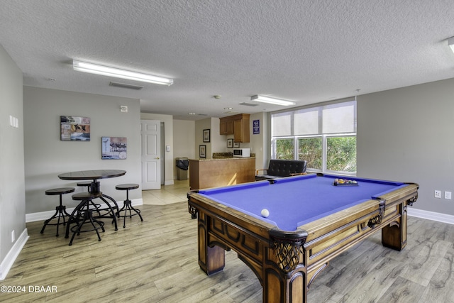 2071 S Atlantic Ave Unit 605, Daytona Beach, FL 32118 - playroom with light wood-style flooring, a textured ceiling, billiards, and baseboards