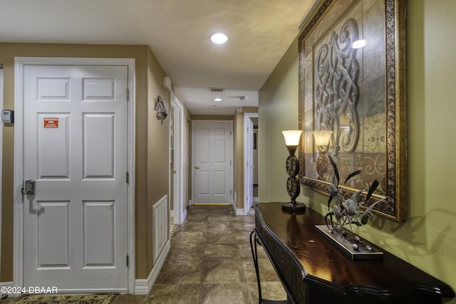 2071 S Atlantic Ave Unit 605, Daytona Beach, FL 32118 - hall featuring baseboards, stone finish floors, and recessed lighting