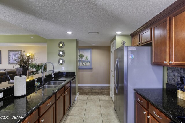 2071 S Atlantic Ave Unit 605, Daytona Beach, FL 32118 - kitchen featuring a sink, stainless steel appliances, dark stone countertops, open floor plan, and recessed lighting