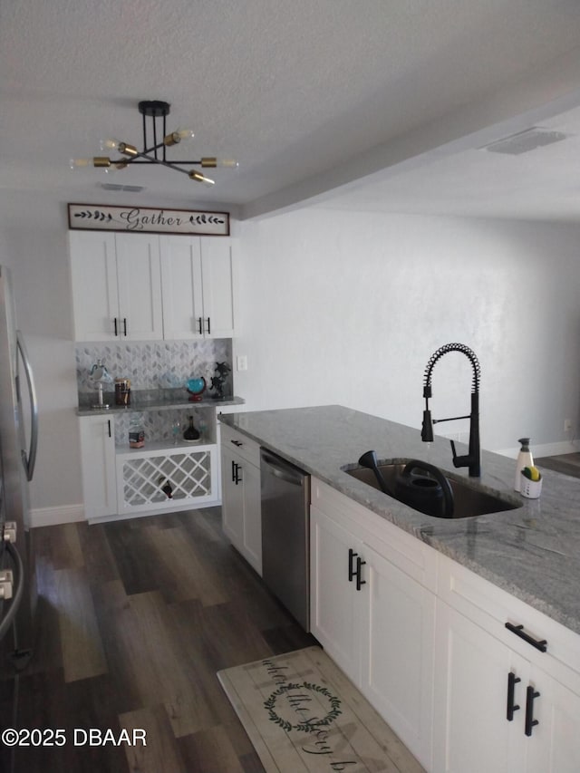 3 Sea Watch Ter, Ormond Beach, FL 32176 - kitchen featuring white cabinetry, appliances with stainless steel finishes, light stone countertops, and a sink