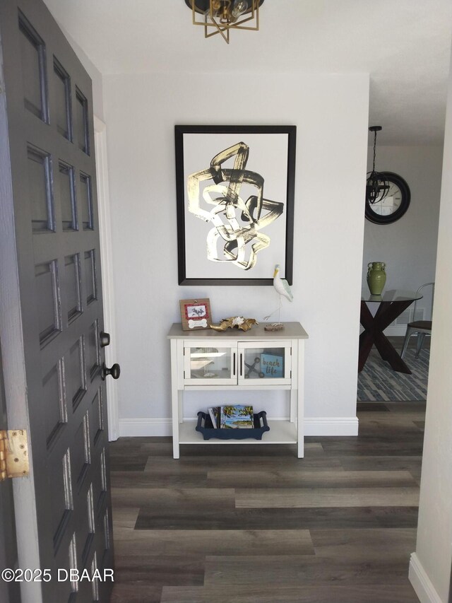 3 Sea Watch Ter, Ormond Beach, FL 32176 - foyer with a notable chandelier, dark wood-style floors, and baseboards