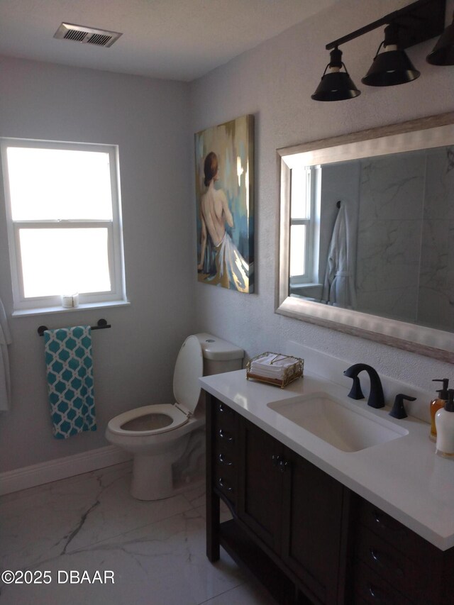 3 Sea Watch Ter, Ormond Beach, FL 32176 - bathroom featuring vanity, baseboards, visible vents, toilet, and marble finish floor