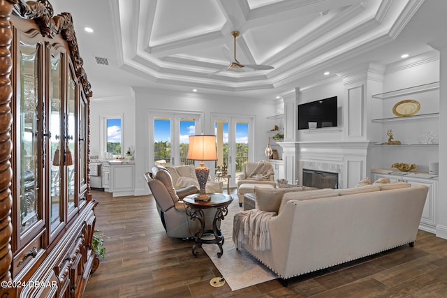 living room featuring a fireplace, ornamental molding, dark hardwood / wood-style flooring, and coffered ceiling