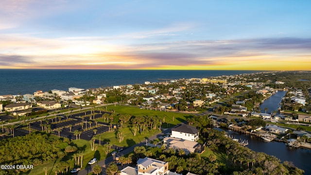 aerial view at dusk with a water view