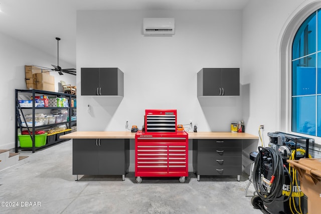 interior space with ceiling fan and a wall mounted AC