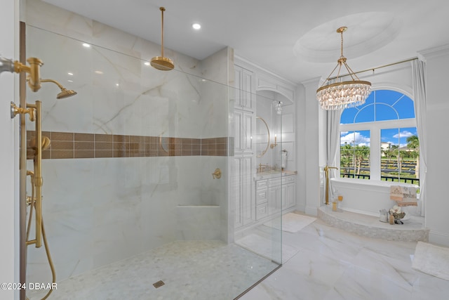 bathroom featuring vanity, a tile shower, and an inviting chandelier