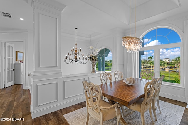 dining area featuring ornamental molding, a wealth of natural light, a notable chandelier, and dark hardwood / wood-style floors