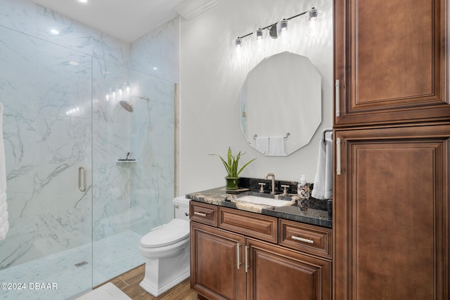 bathroom with vanity, toilet, and an enclosed shower