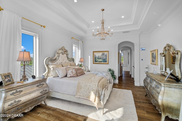 bedroom featuring ornamental molding, dark wood-type flooring, multiple windows, and a raised ceiling