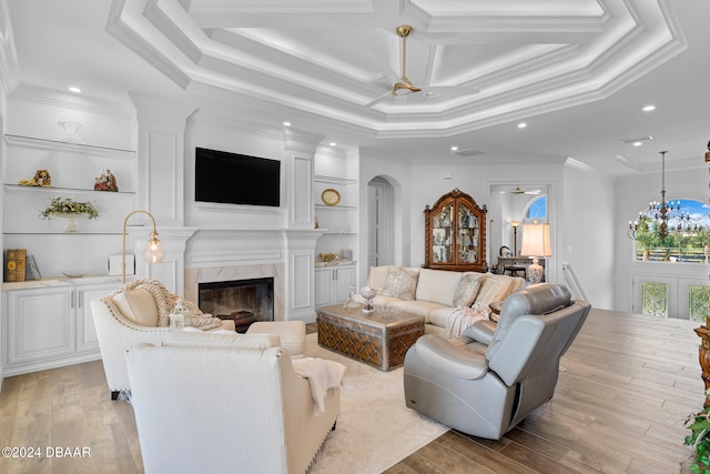 living room with a fireplace, light hardwood / wood-style flooring, and crown molding