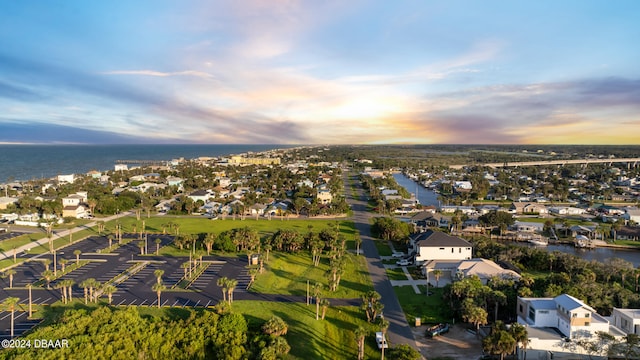 aerial view at dusk with a water view