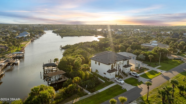 aerial view at dusk with a water view