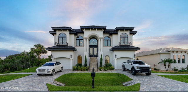 mediterranean / spanish-style house with a front lawn and a garage