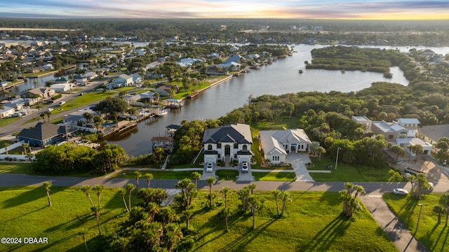 aerial view at dusk with a water view