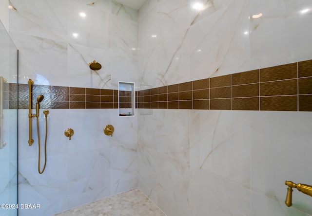 bathroom with a tile shower