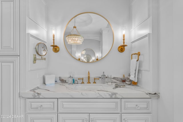 bathroom featuring vanity and a notable chandelier