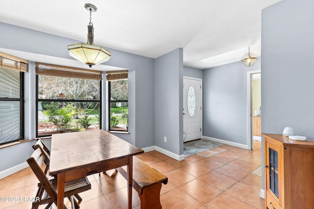 dining room featuring baseboards and light tile patterned flooring