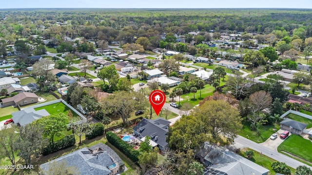 birds eye view of property featuring a residential view and a wooded view