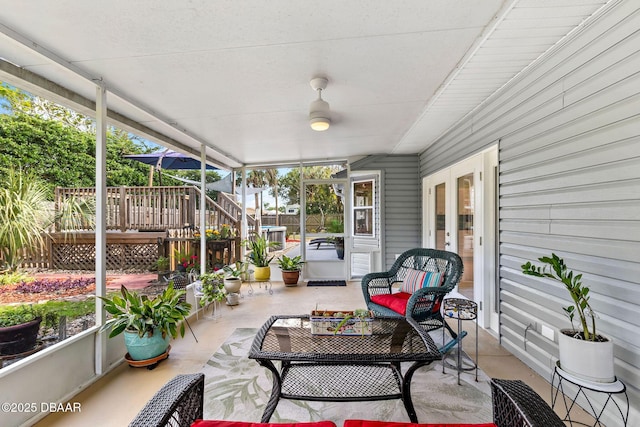 sunroom / solarium with plenty of natural light and ceiling fan