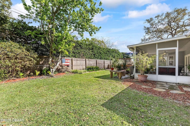 view of yard featuring fence and a sunroom