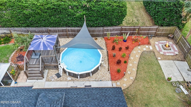 view of pool with a fenced backyard