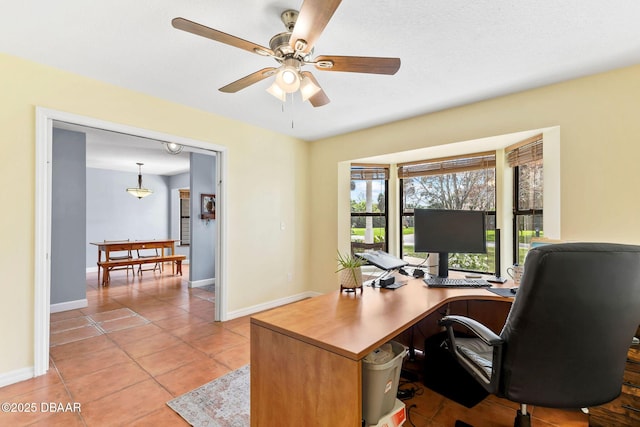 office space featuring light tile patterned flooring, ceiling fan, and baseboards