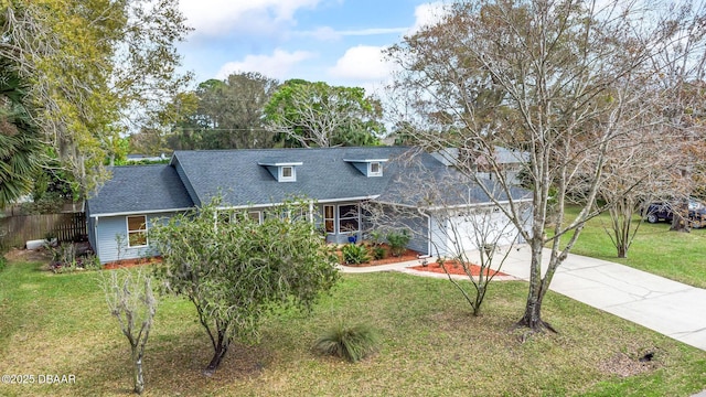 view of front of home featuring a garage, concrete driveway, and a front lawn