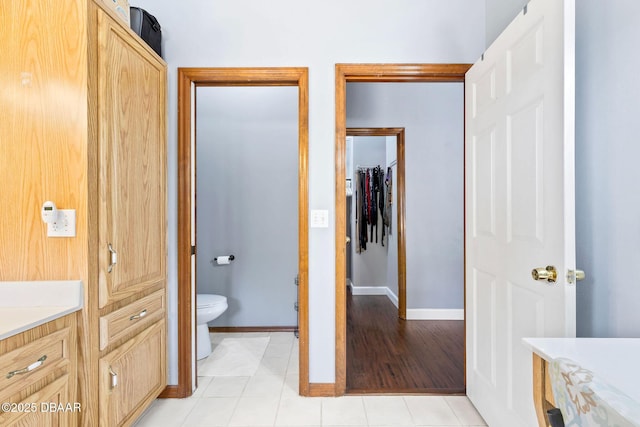 full bathroom featuring baseboards, vanity, toilet, and tile patterned floors