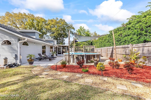 view of yard with a fenced backyard, a fenced in pool, and a patio