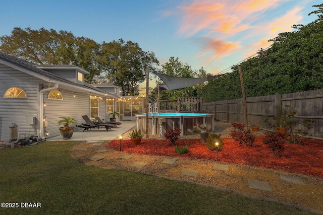 view of yard with a patio area, a fenced backyard, and a fenced in pool