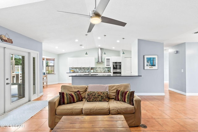 living area with light tile patterned floors, recessed lighting, a ceiling fan, baseboards, and vaulted ceiling