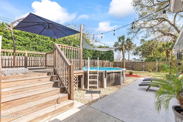 view of patio featuring a fenced in pool, a fenced backyard, and a deck