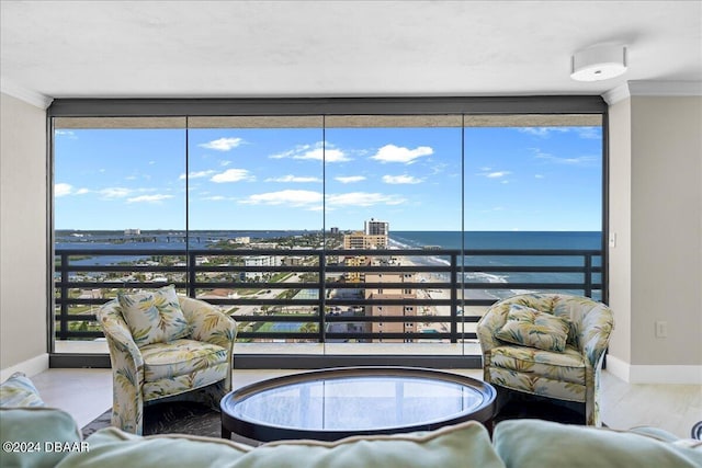 living room with wood-type flooring, a water view, and crown molding