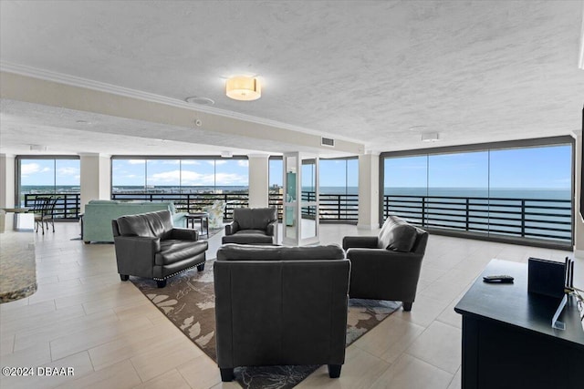 living room with expansive windows, a water view, and a textured ceiling