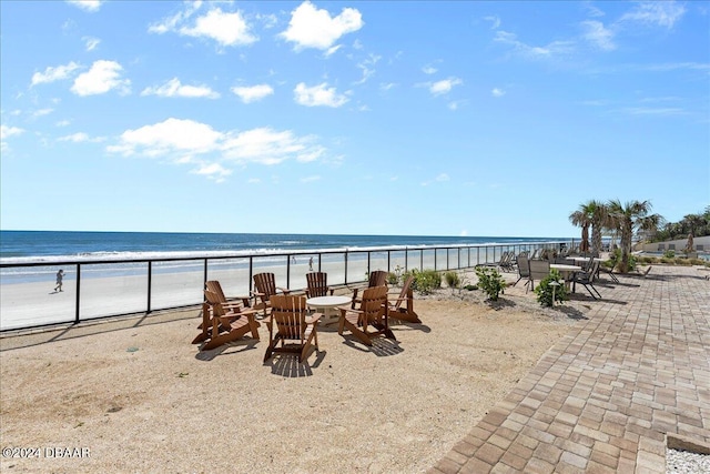 view of patio featuring a view of the beach and a water view