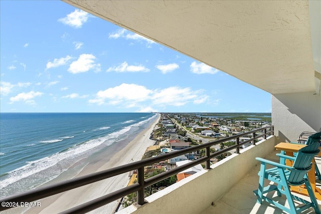 balcony with a beach view and a water view