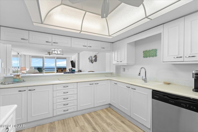 kitchen featuring white cabinetry, a notable chandelier, sink, dishwasher, and light hardwood / wood-style flooring