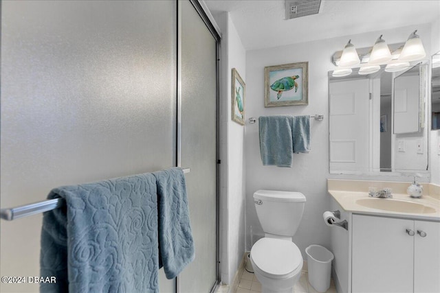 bathroom with toilet, vanity, tile patterned flooring, and walk in shower