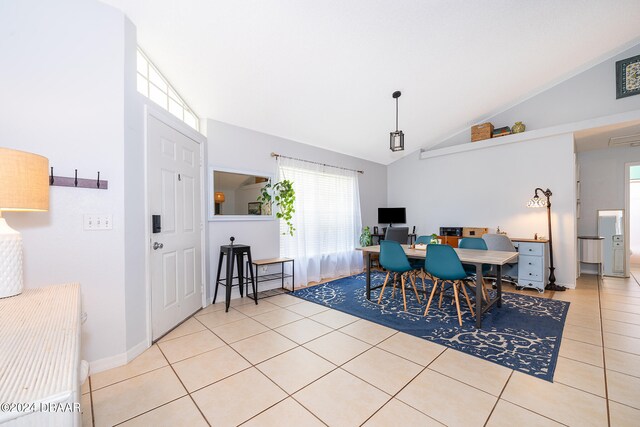 tiled dining area with lofted ceiling