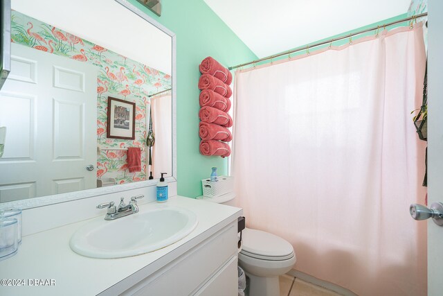 bathroom featuring tile patterned flooring, vanity, and toilet