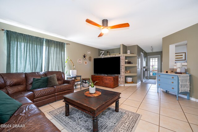 tiled living room with ceiling fan